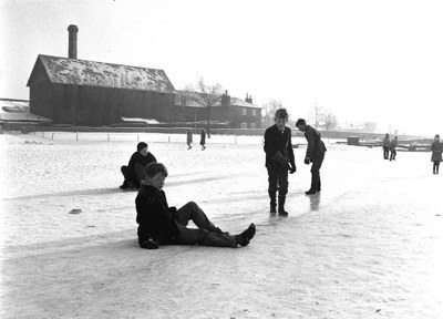 Kids sliding on the frozen Canal Basin, 26 January 1963.